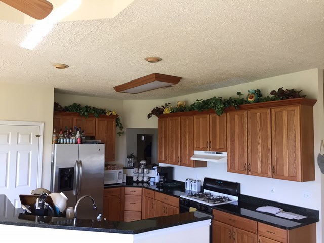 409 Torbet Road, Unit 1A1 Forsyth, GA 31029 - Photo 10 of 29 a kitchen with granite countertop a sink and a stove