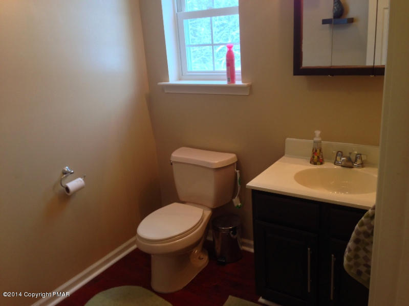 1148 Sunside Road Long Pond, PA 18334 - Photo 14 of 20 a bathroom with a toilet a sink and a window