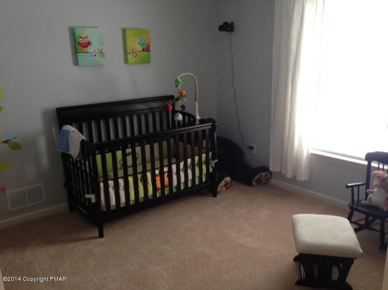 1148 Sunside Road Long Pond, PA 18334 - Photo 16 of 20 a bedroom with a bed and a window