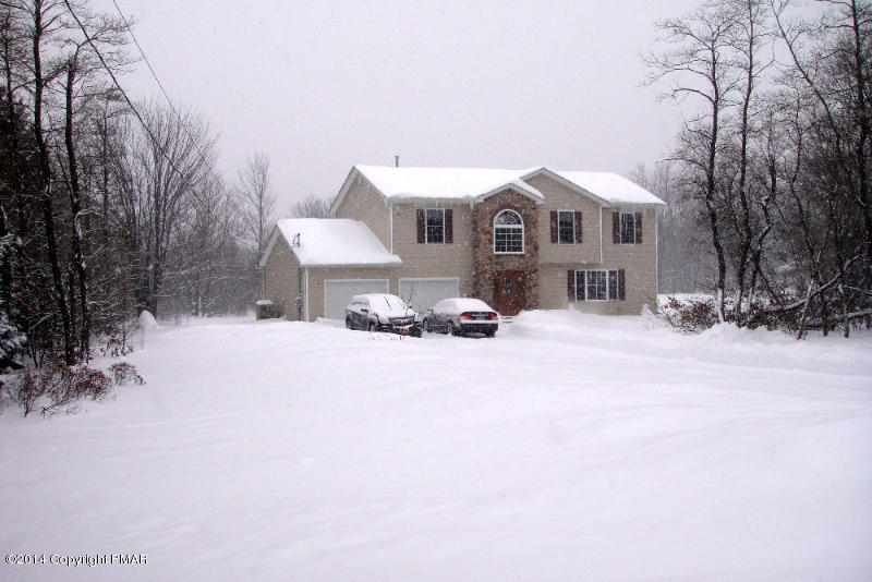 1148 Sunside Road Long Pond, PA 18334 - Photo 18 of 20 a front view of a house with a yard covered in snow