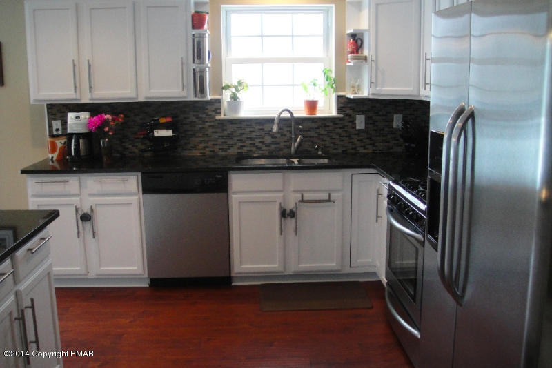 1148 Sunside Road Long Pond, PA 18334 - Photo 3 of 20 a kitchen with stainless steel appliances granite countertop a sink stove and refrigerator