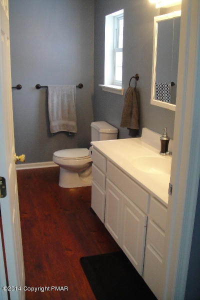 1148 Sunside Road Long Pond, PA 18334 - Photo 5 of 20 a living room with a toilet a sink and a window