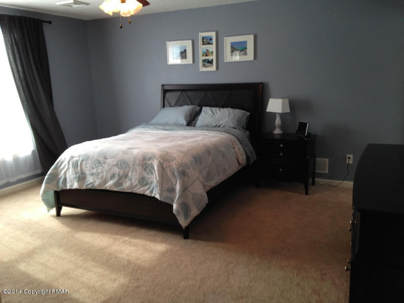 1148 Sunside Road Long Pond, PA 18334 - Photo 8 of 20 a bed sitting in a bedroom next to a window