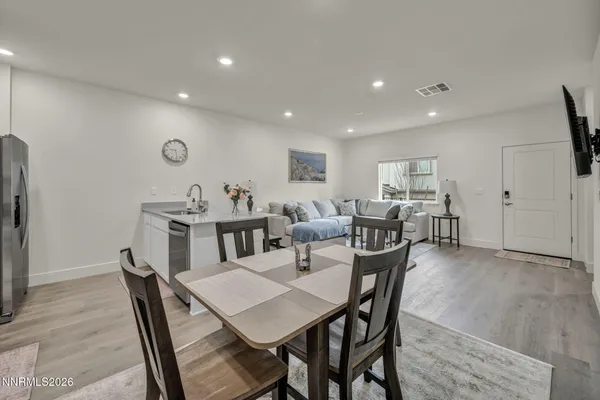 a living room with lots of furniture and a wooden floor