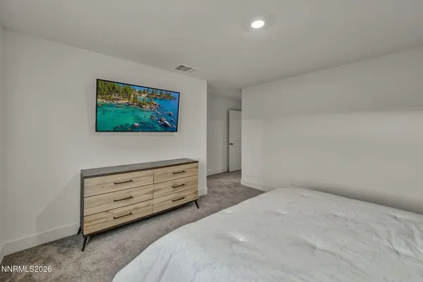 a bathroom with a double vanity sink toilet mirror and shower