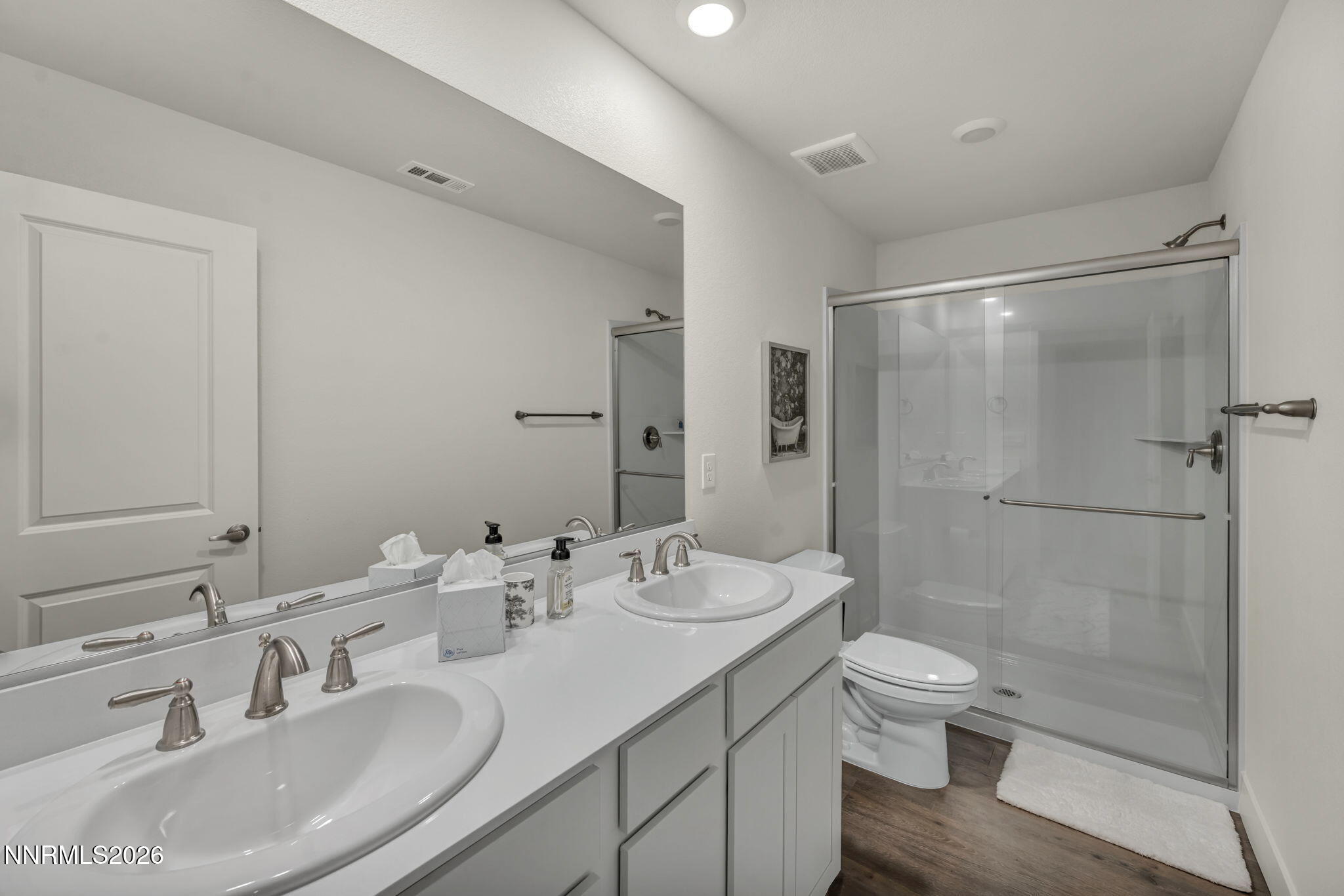 1634 Icelandic Way Reno, NV 89523 - Photo 22 of 49 a bathroom with a double vanity sink toilet mirror and shower