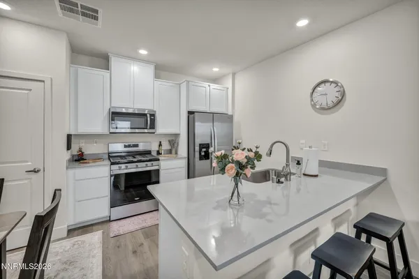 a kitchen with kitchen island a sink stove and refrigerator