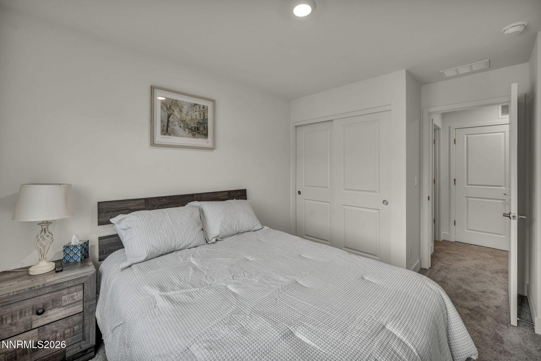 1634 Icelandic Way Reno, NV 89523 - Photo 31 of 49 a bedroom with a bed and a lamp on dresser