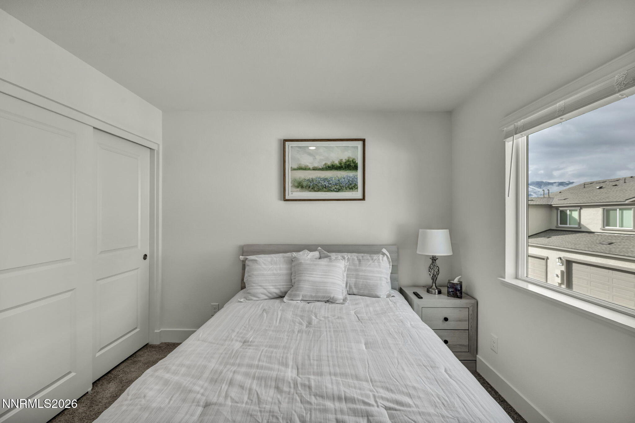 1634 Icelandic Way Reno, NV 89523 - Photo 36 of 49 a bedroom with a bed and a large mirror next to a window