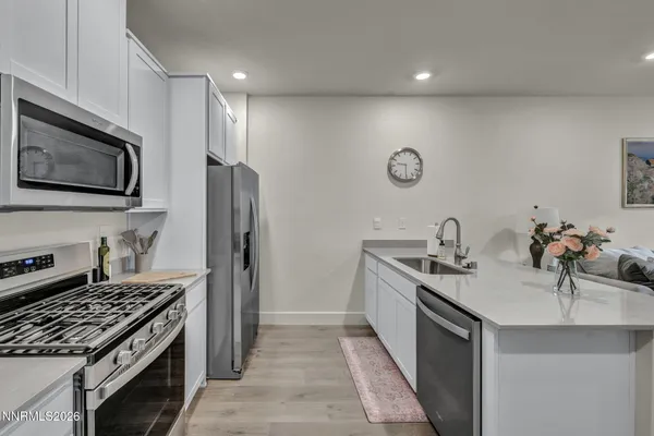 a kitchen with stainless steel appliances a sink stove and refrigerator