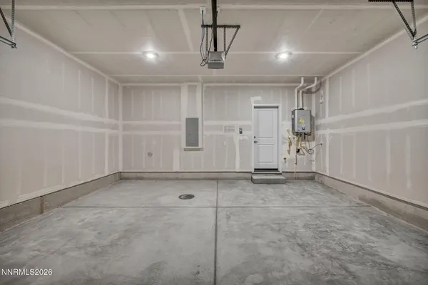 a view of a building with barbeque and wooden fence