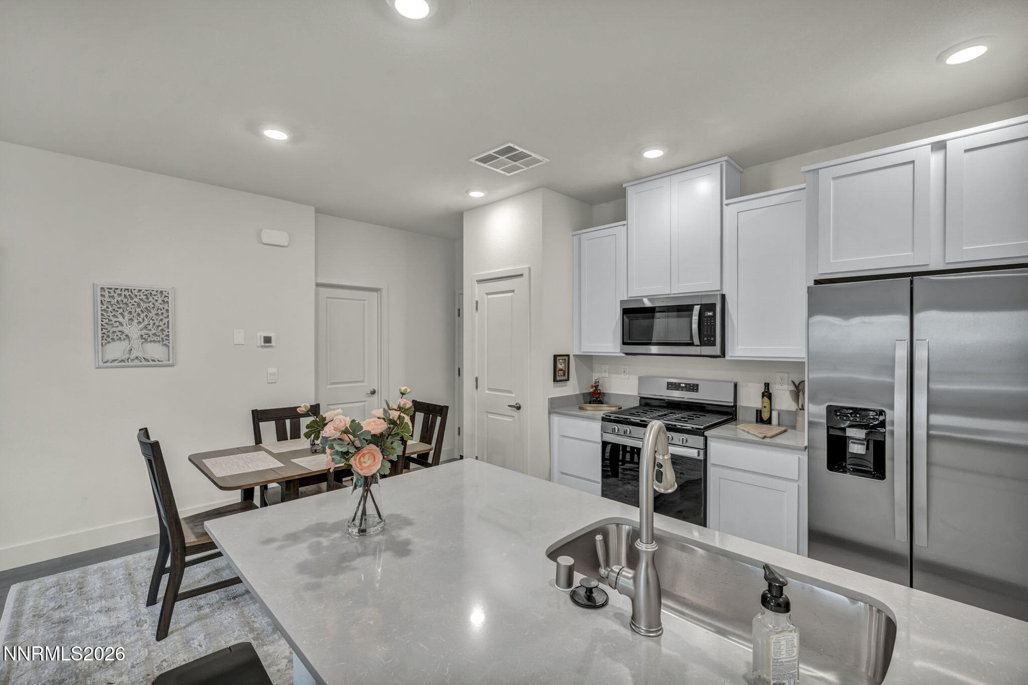 1634 Icelandic Way Reno, NV 89523 - Photo 5 of 49 a kitchen with kitchen island a large counter top space appliances and cabinets