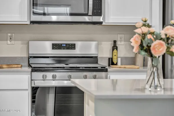a kitchen with a stove and cabinets