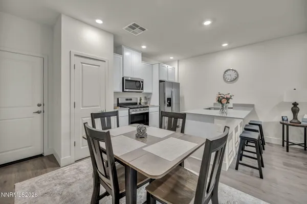 a view of a dining room with furniture and wooden floor