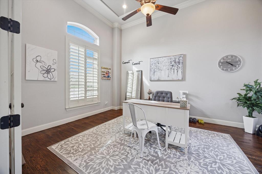 580 Butchart Drive Prosper, TX 75078 - Photo 13 of 40 Office area featuring ornamental molding, ceiling fan, a towering ceiling, wood finished floors, and baseboards