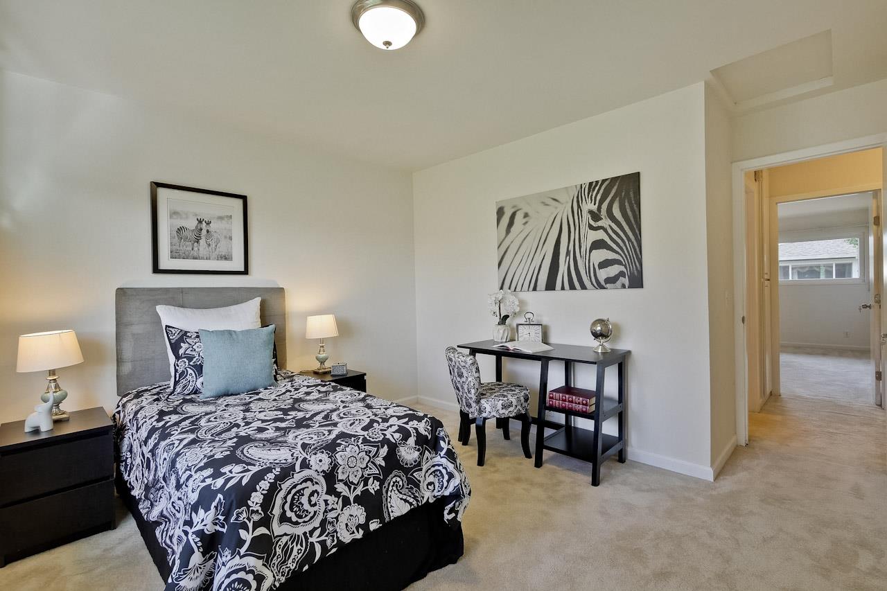 1133 Reed Avenue, Unit B Sunnyvale, CA 94086 - Photo 14 of 33 a bed sitting in a bedroom next to a lamp