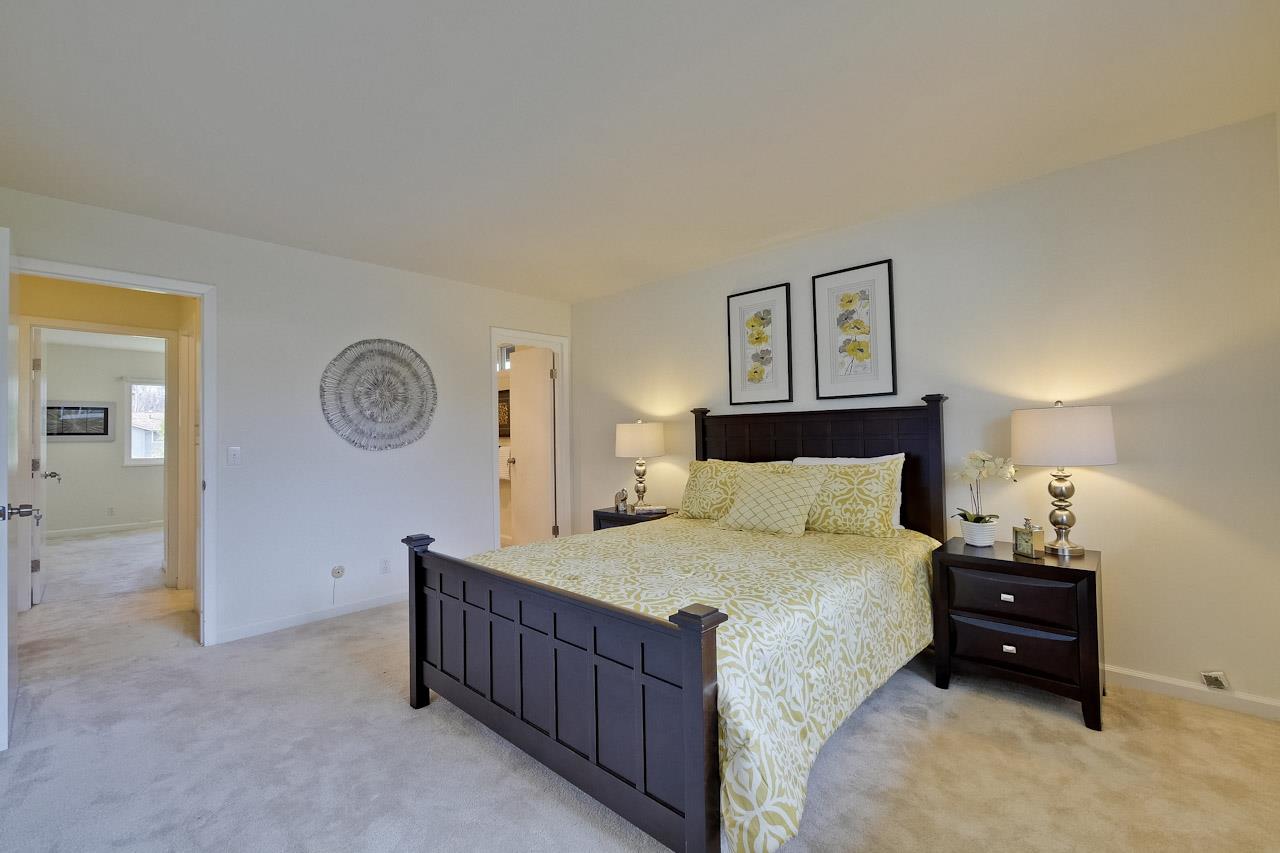 1133 Reed Avenue, Unit B Sunnyvale, CA 94086 - Photo 18 of 33 a bedroom with a bed and a chandelier
