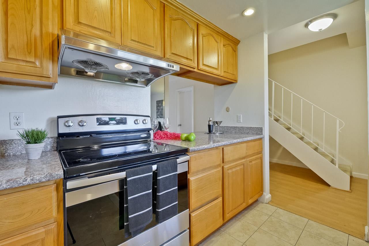 1133 Reed Avenue, Unit B Sunnyvale, CA 94086 - Photo 5 of 33 a kitchen with stainless steel appliances granite countertop a stove and cabinets