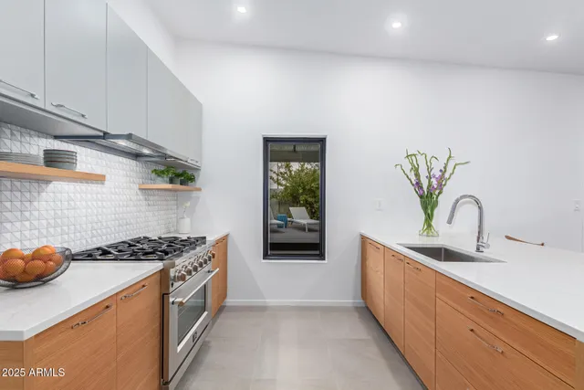 a kitchen with a stove and a white cabinet