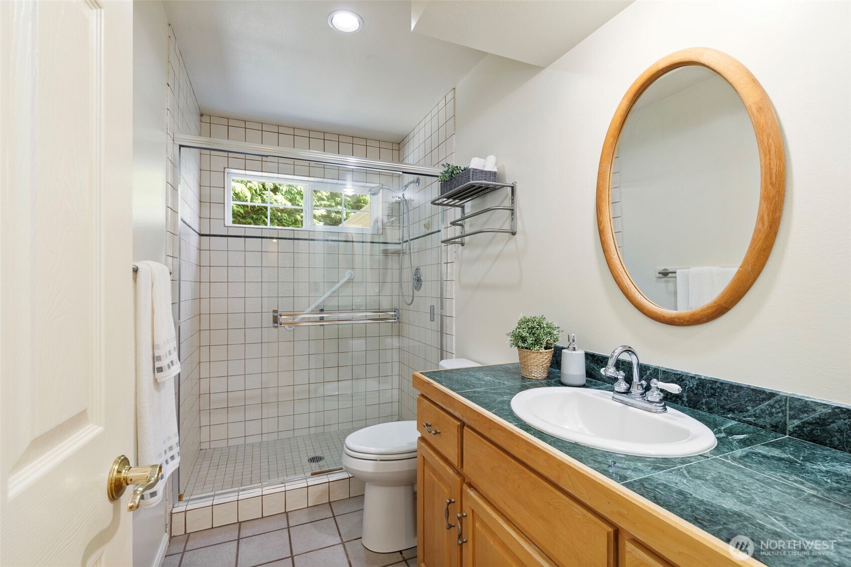 1757 Maple Street Port Townsend, WA 98368 - Photo 21 of 40 a bathroom with a sink a toilet and a mirror