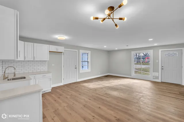 a view of a kitchen with a sink and cabinet