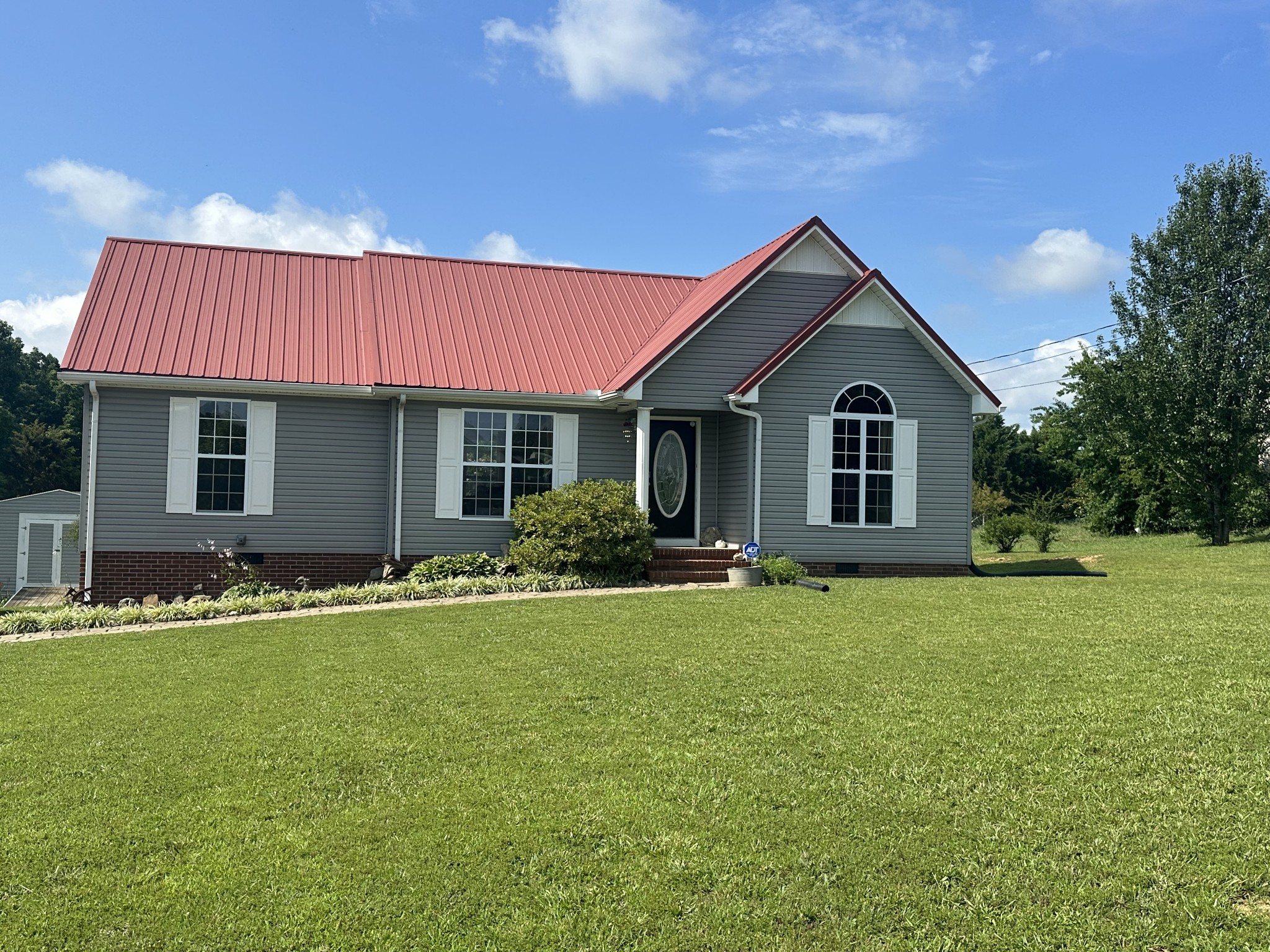 a front view of a house with a yard