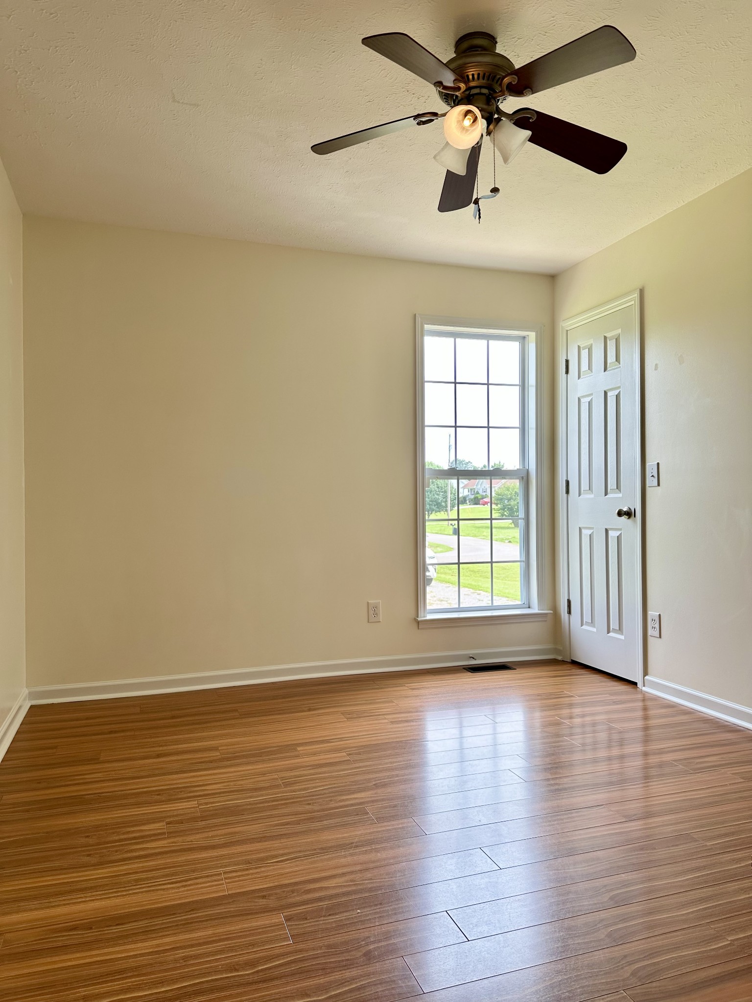 26 Ridgeline Drive Fayetteville, TN 37334 - Photo 22 of 39 a view of an empty room with window and wooden floor