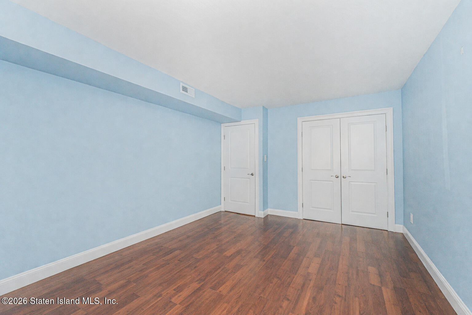 4199A Amboy Road, Unit 5A Staten Island, NY 10308 - Photo 16 of 19 a view of an empty room with wooden floor