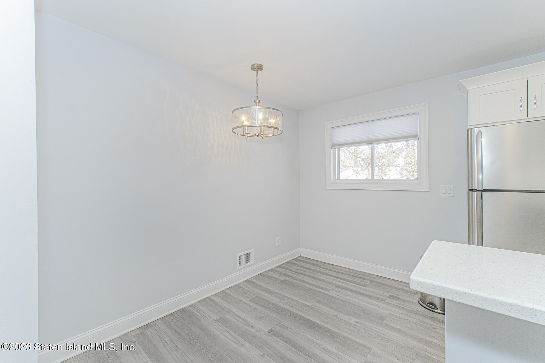 4199A Amboy Road, Unit 5A Staten Island, NY 10308 - Photo 4 of 19 a room with a wooden floor and white walls