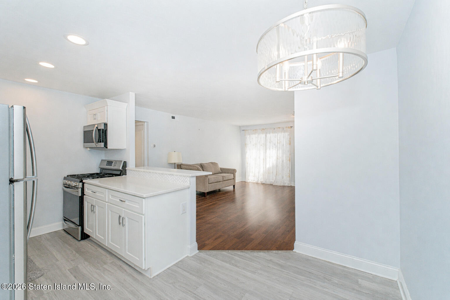 4199A Amboy Road, Unit 5A Staten Island, NY 10308 - Photo 10 of 19 a kitchen with stainless steel appliances a stove a refrigerator and a chandelier