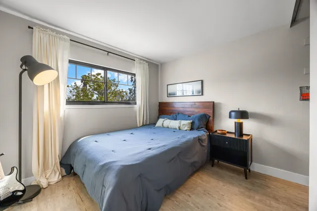 a bedroom with a bed and a window