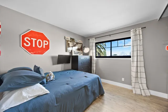 a bedroom with a bed and a window