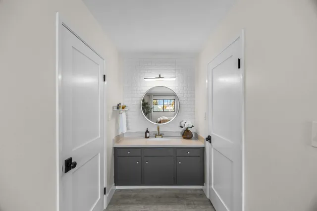 a bathroom with a toilet a sink a mirror and vanity