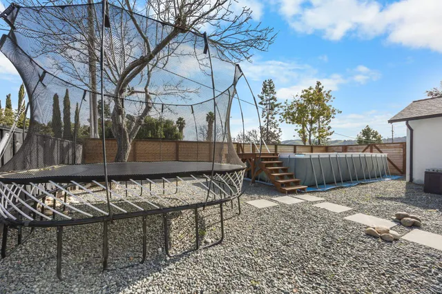 a view of wooden deck with a backyard