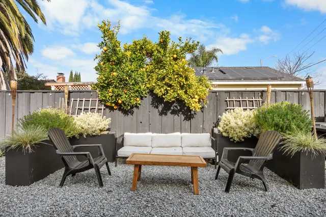 a swimming pool with outdoor seating and plants