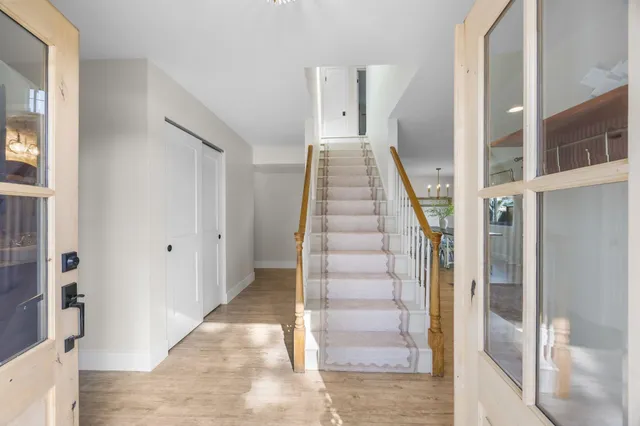 a view of entryway with furniture and wooden floor