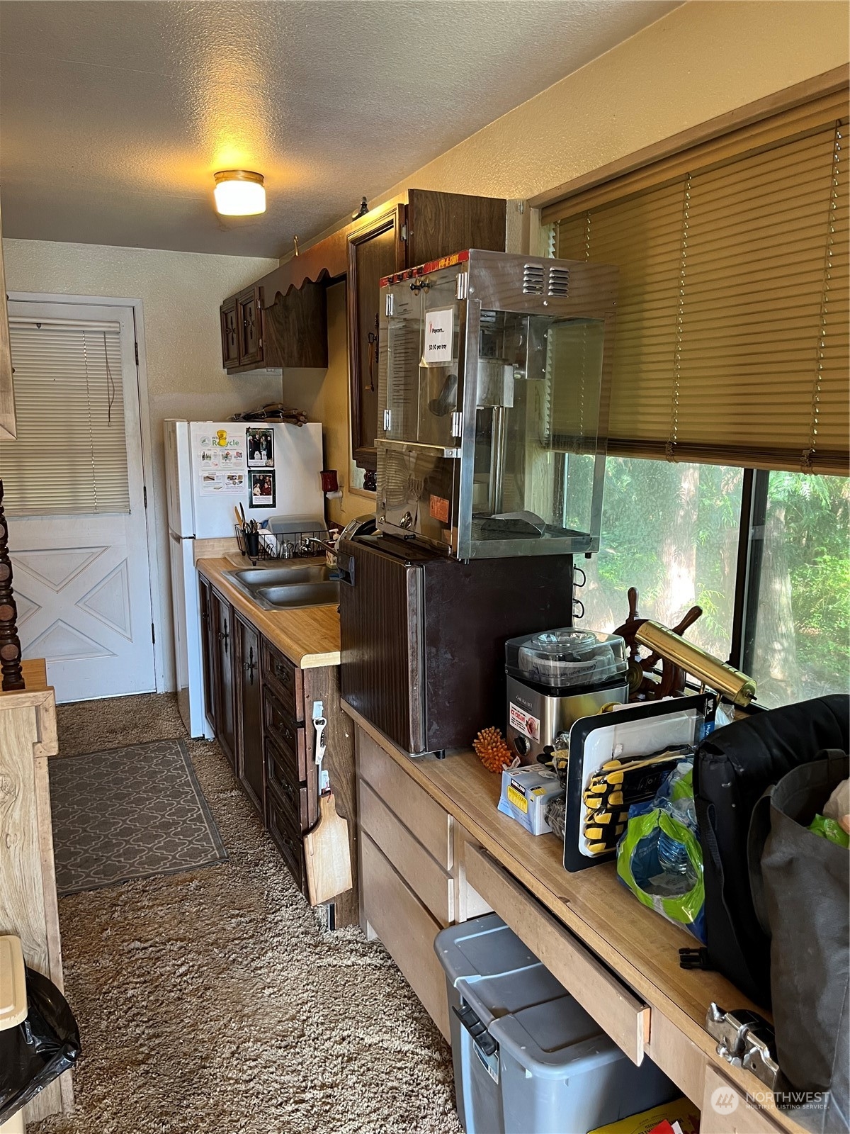1481 Griffith Point Road Nordland, WA 98358 - Photo 11 of 39 a kitchen with stainless steel appliances granite countertop a stove a sink and a refrigerator