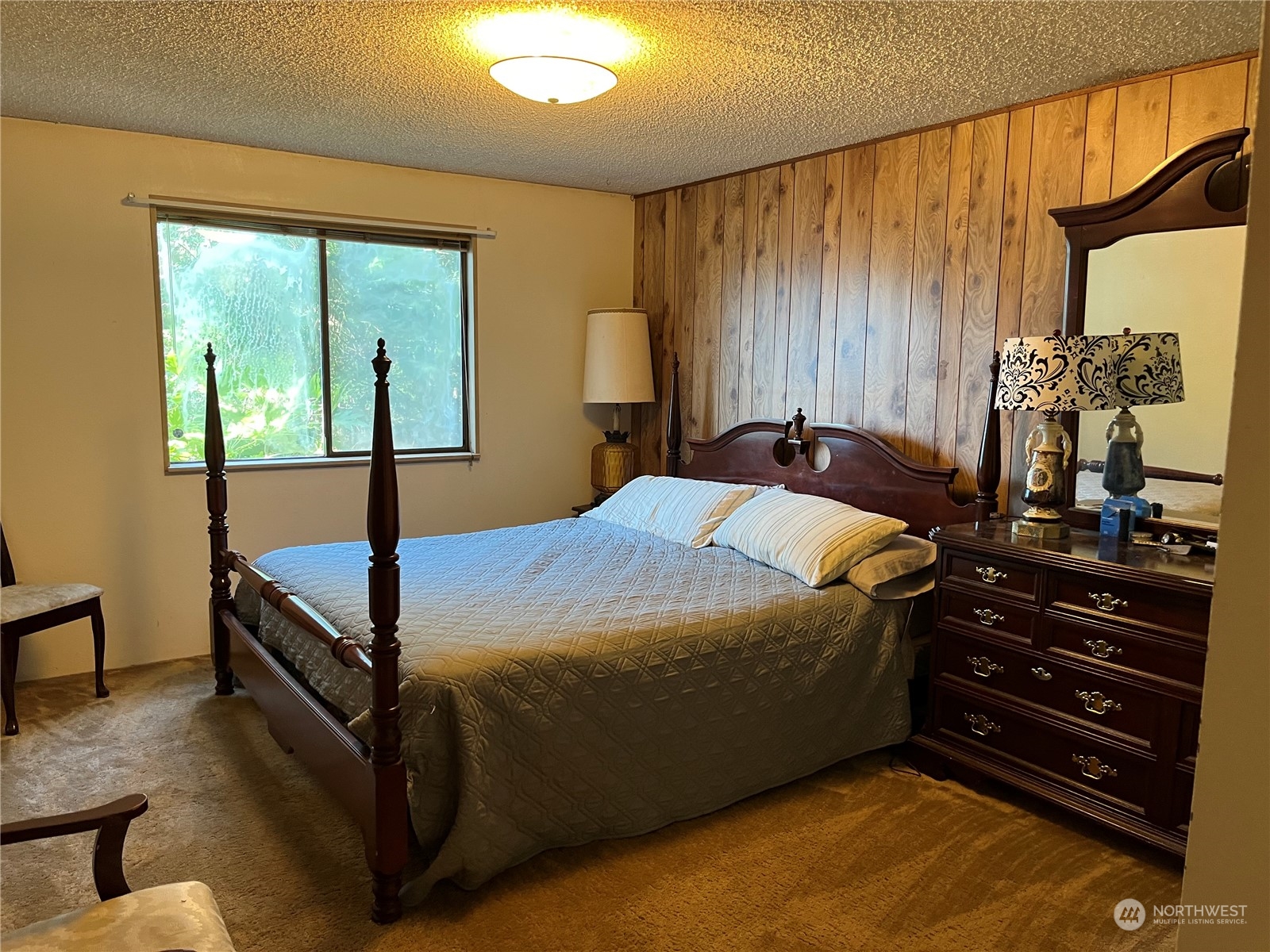 1481 Griffith Point Road Nordland, WA 98358 - Photo 12 of 39 a bed sitting in a bedroom next to a window
