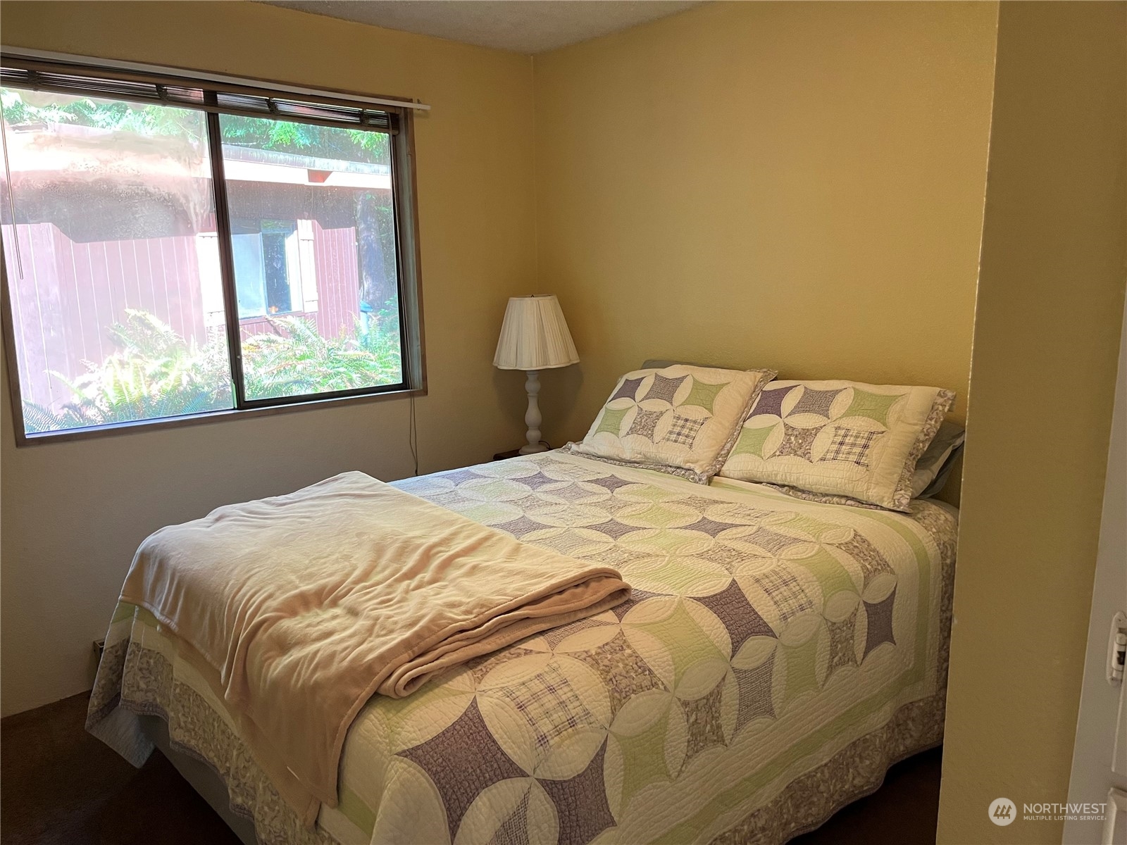 1481 Griffith Point Road Nordland, WA 98358 - Photo 14 of 39 a large bed sitting in a bedroom next to a window