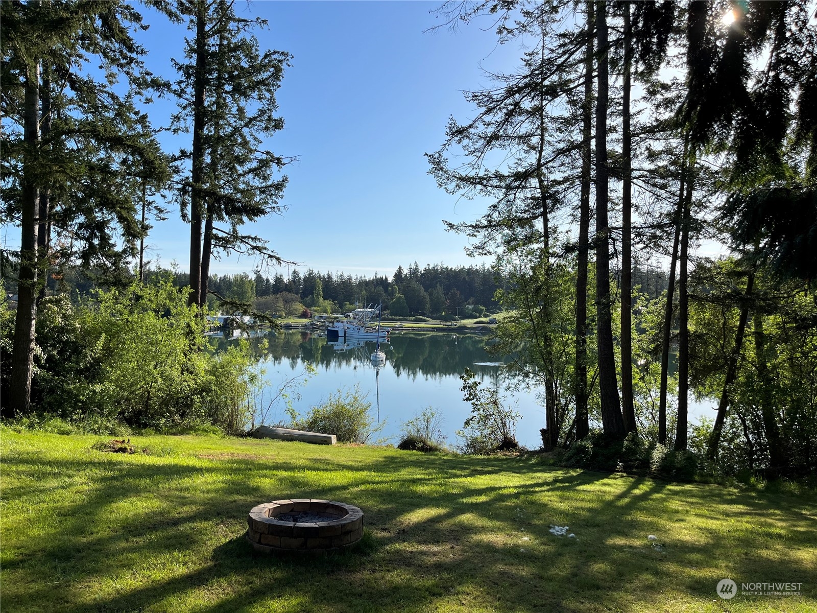 1481 Griffith Point Road Nordland, WA 98358 - Photo 3 of 39 a backyard of a house with lots of green space and lake view