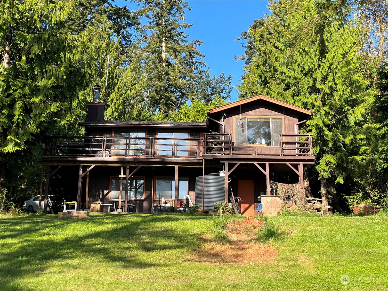 1481 Griffith Point Road Nordland, WA 98358 - Photo 33 of 39 a view of a big house with a big yard and large trees
