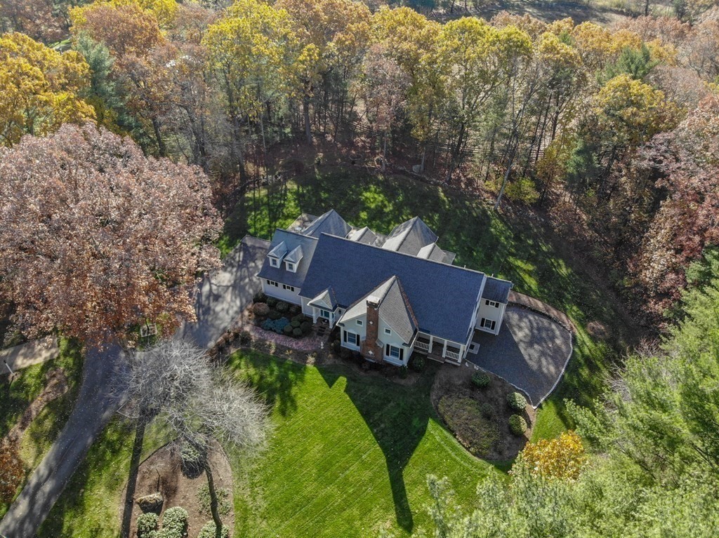 a view of a house with a yard and sitting area