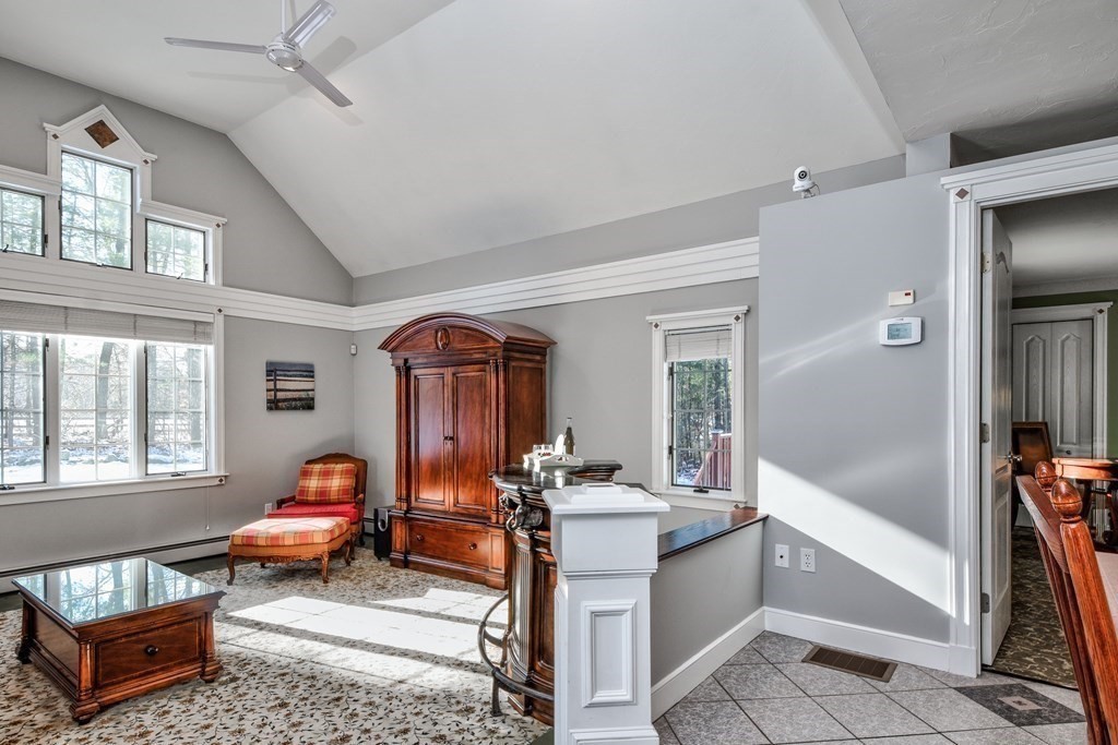 6 Barnbridge Circle Framingham, MA 01701 - Photo 16 of 41 a living room with furniture a window and a chandelier
