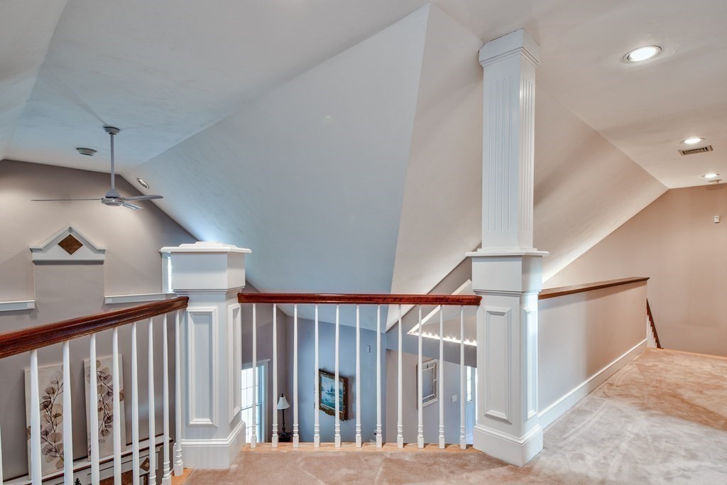 6 Barnbridge Circle Framingham, MA 01701 - Photo 31 of 41 a view of staircase with lots of frames on wall and wooden floor