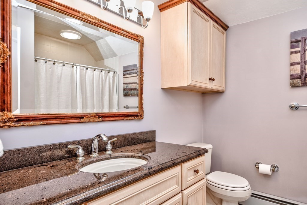 6 Barnbridge Circle Framingham, MA 01701 - Photo 35 of 41 a bathroom with a granite countertop sink a mirror and a toilet