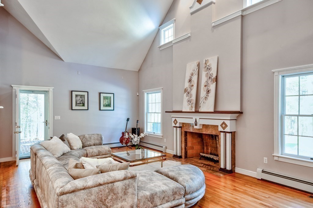 6 Barnbridge Circle Framingham, MA 01701 - Photo 8 of 41 a living room with furniture a window and a fireplace