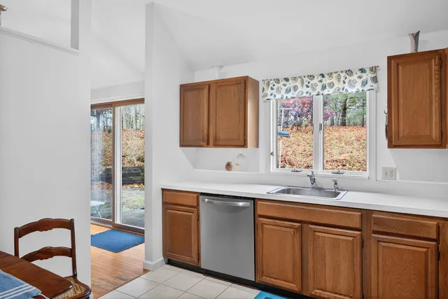 a kitchen with stainless steel appliances granite countertop a sink and a window
