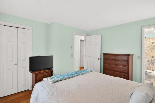 a bedroom with a bed and a television