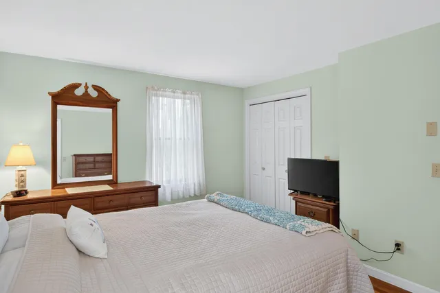 a bedroom with a bed and a tv