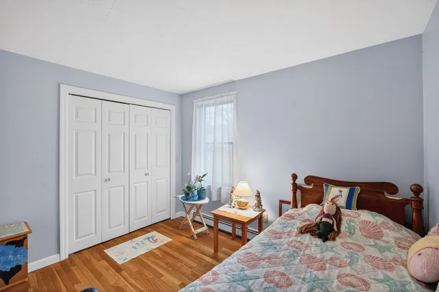 a bedroom with bed and window